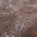 A full-frame textured surface with a distressed, weathered finish in mottled brown, gray, and off-white tones.